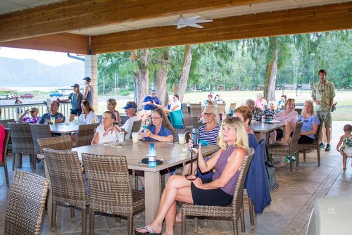 a group of people sitting around the table 