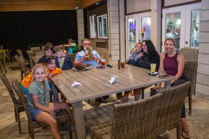 a group of people sitting around  the table 