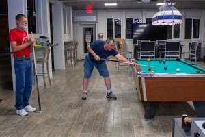 a person playing pool in a room<br />
