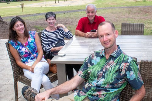 a group of people sitting at the table<br />
