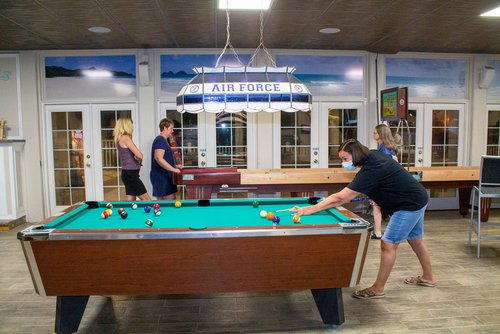 group of people playing billiards