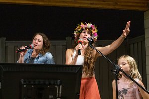 ladies singing into a microphone