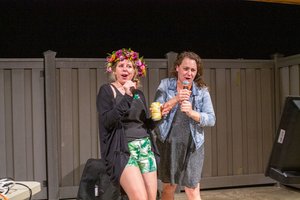 ladies singing into a microphone