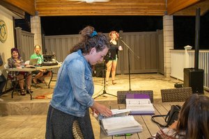 a person standing at a table with books on it<br />
