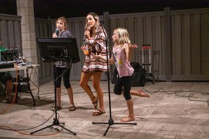 kids singing into a microphone