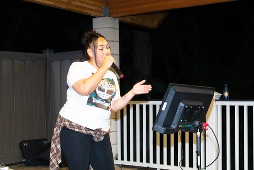 a woman singing to the microphone