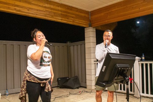 a man and a woman singing on the microphone