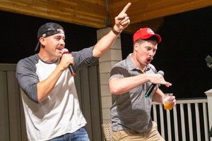 men singing into the microphone