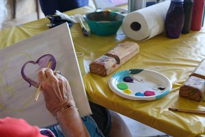 a person painting on a table<br />
