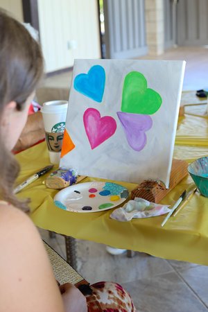 a person painting on a table<br />
