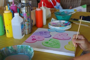 a person painting on a table<br />
