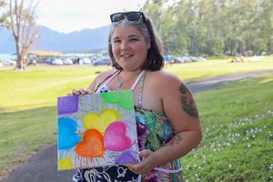 a girl holding a painting