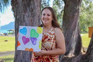 a girl holding a painting<br />
