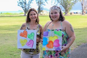 ladies holding paintings