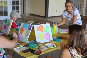 a group of people painting on a table<br />
