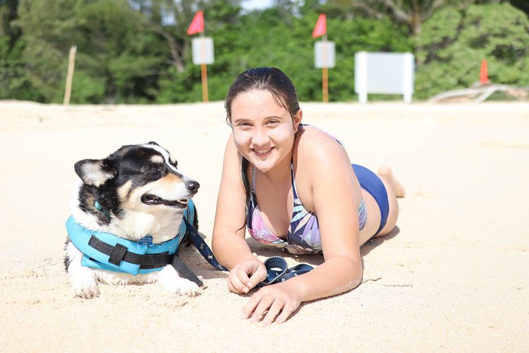 a lady with her dog in the beach