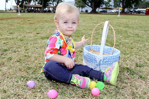 a child sitting on a grass