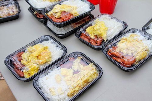 a table with plastic containers of food<br />
