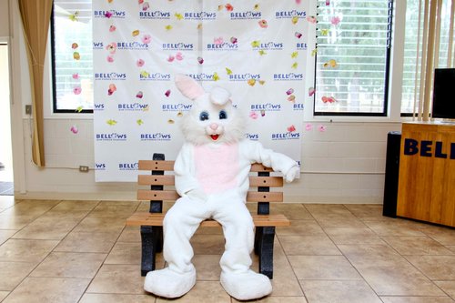 a person in a bunny garment sitting on a bench<br />
