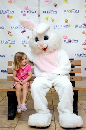  a kid sitting on a bench with a person in a bunny garment<br />
