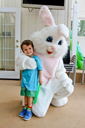 a kid  with a person in a bunny garment<br />
