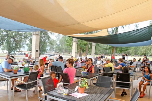 a group of people sitting at tables<br />
