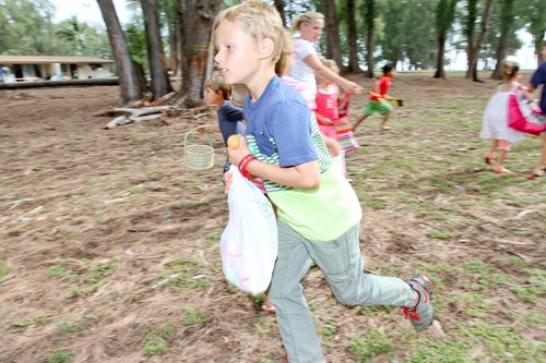 a group of children running in a park<br />
