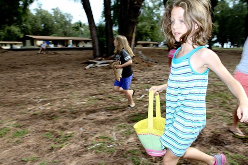 a group of children running in a park<br />
