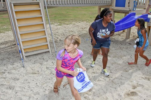 a child holding a plastic bag