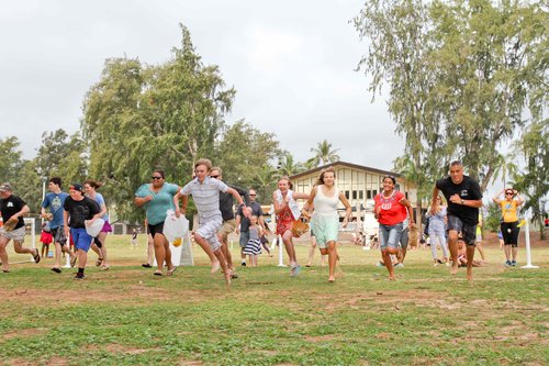 a group of people running on grass<br />
