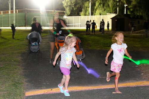 a group of children running in a park<br />
