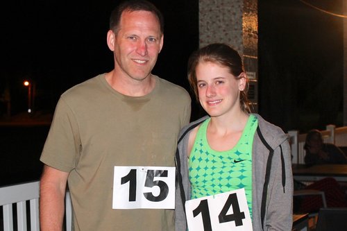 a person and person standing together with numbers on their shirts<br />
