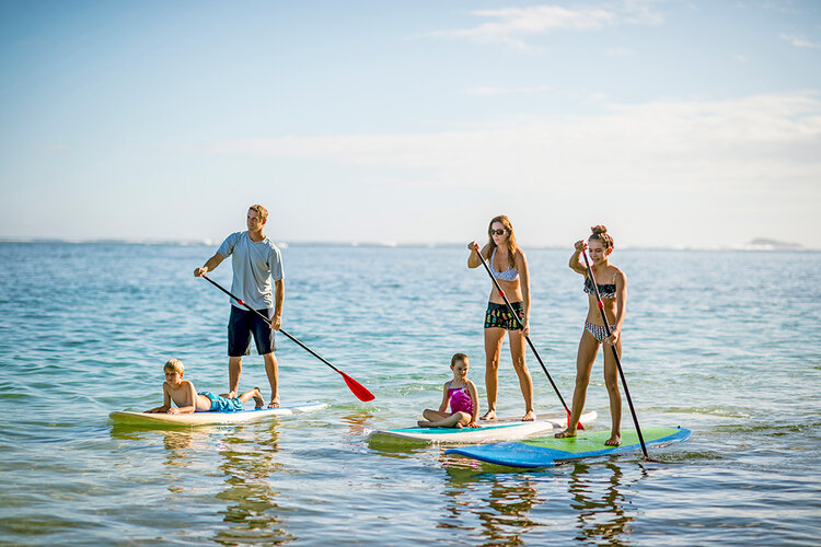 a group of people on paddle boards in the water