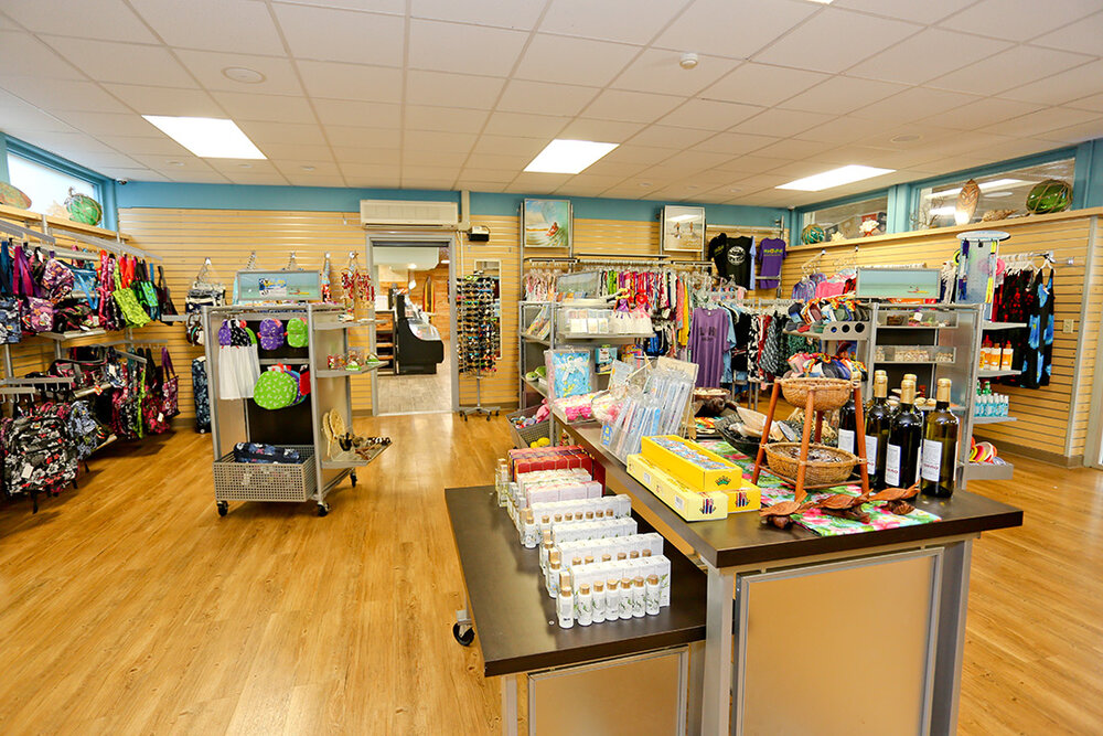 a store with shelves of clothing and items