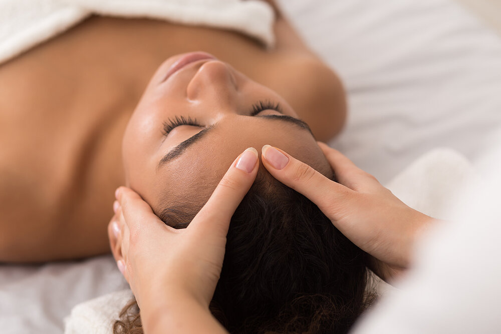 a person receiving a head massage