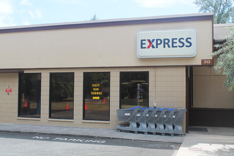 a store front with shopping carts outside