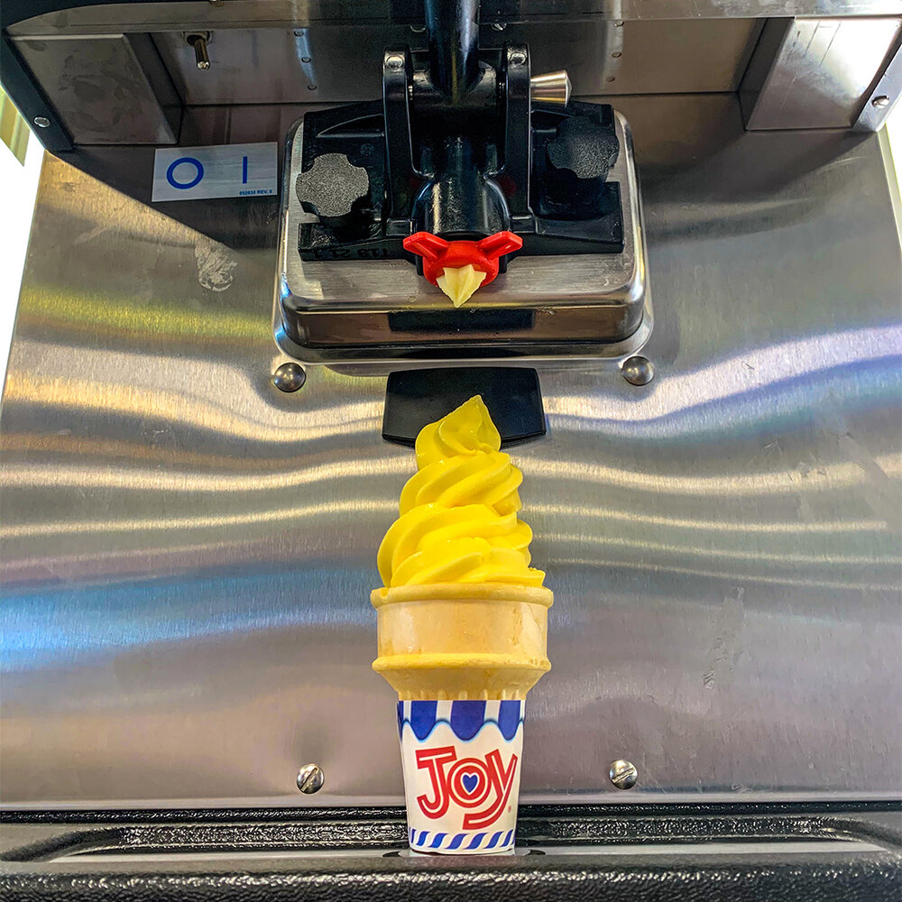 a yellow and blue ice cream cone on a machine