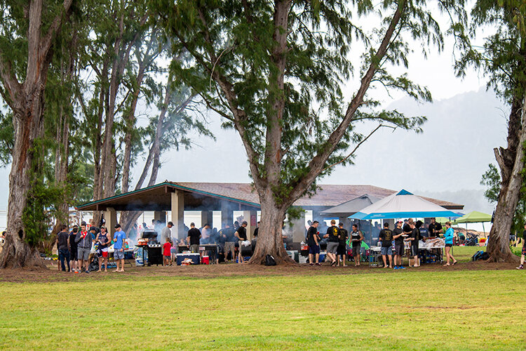 a group of people outside under a tree