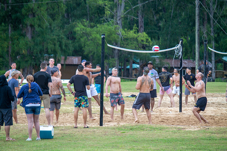 a group of people playing volleyball