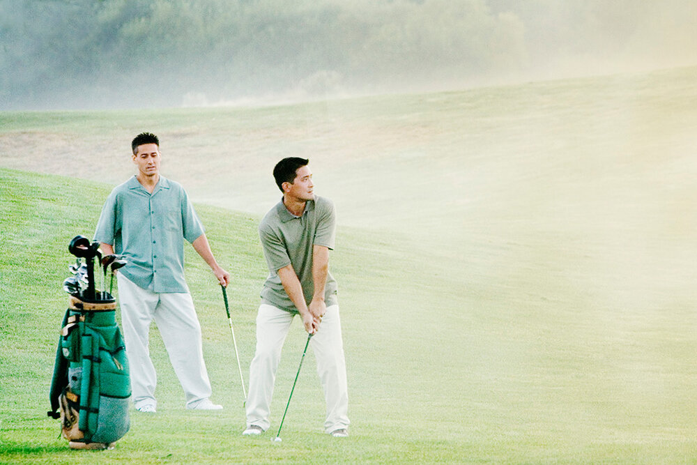 a group of men playing golf