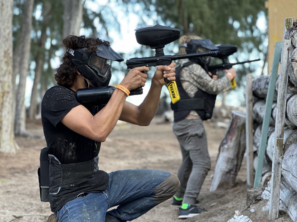 a group of people shooting paintball guns