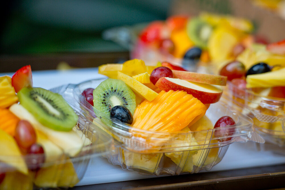 a group of plastic containers of fruit