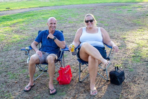 man and woman sitting in the chair outside