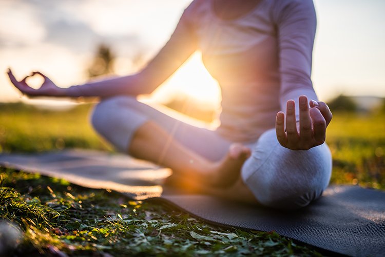 a person sitting in a yoga pose