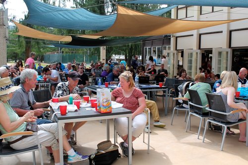 a group of people sitting at tables<br />
