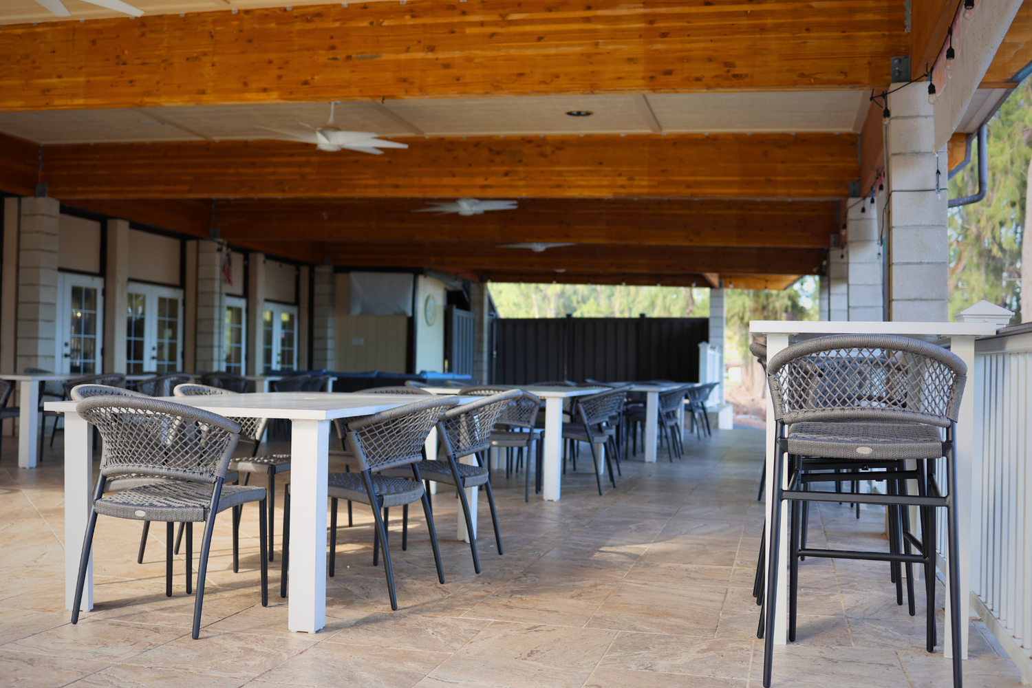 a patio with tables and chairs